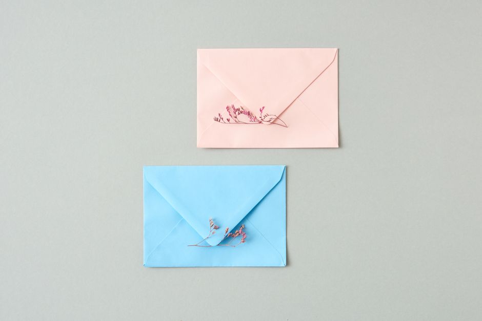 Minimalist stationery with pastel-colored envelopes and delicate flowers, perfect for invitations or announcements.